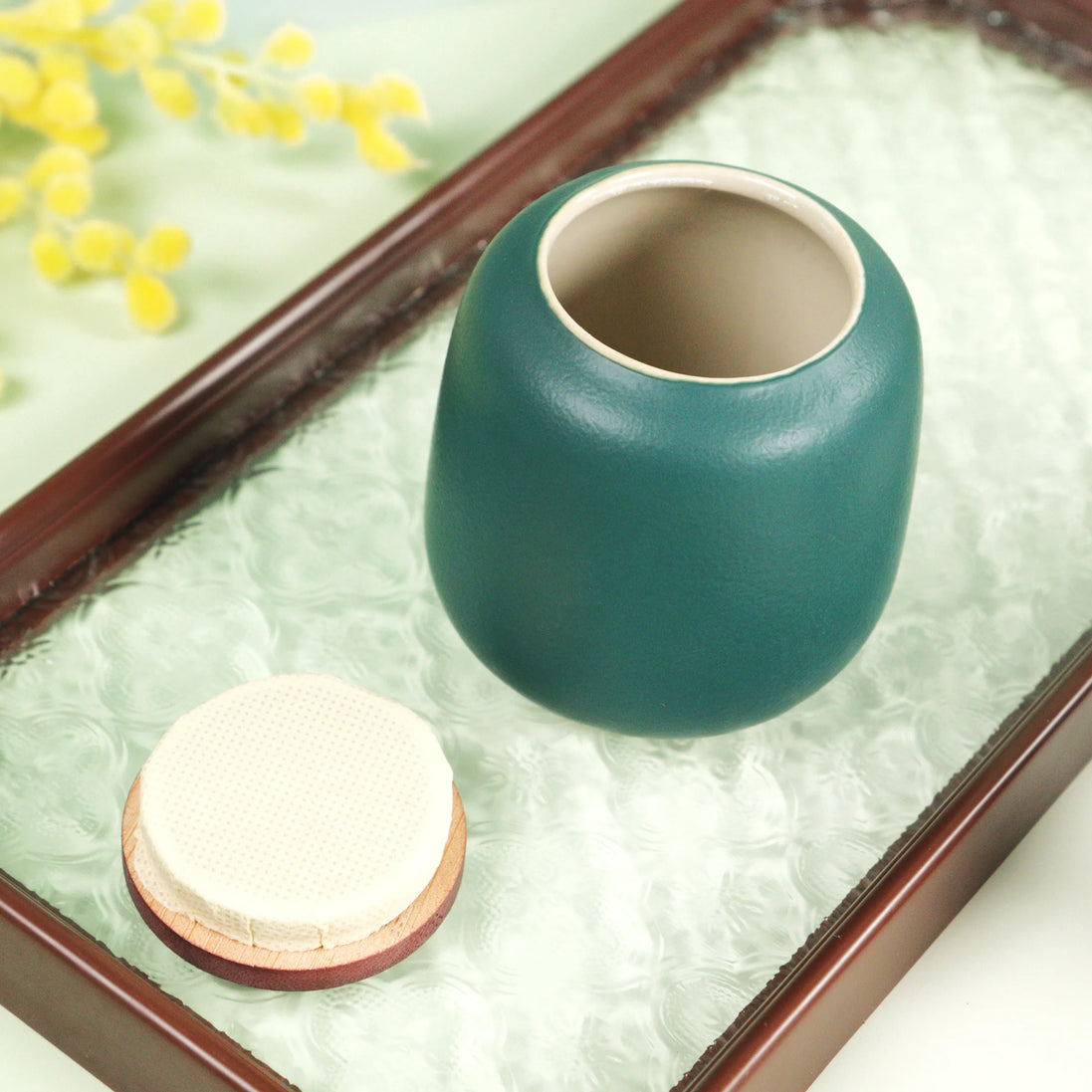 Aurora ceramic jar in teal with wooden lid on decorative tray