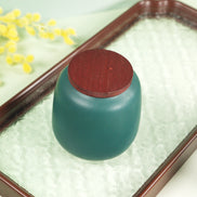 Aurora jar in teal with timber lid on decorative tray