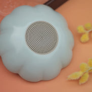 Cloud-shaped silicone tea strainer in soft blue with mesh filter on peach background