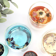 Herbal tea collection in glass cups with dried flowers and butterfly pea on white background