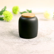 Kin Jar black ceramic storage container with bamboo lid on granite benchtop