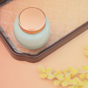 Lily jar in mint green with rose gold lid on terracotta packing cube