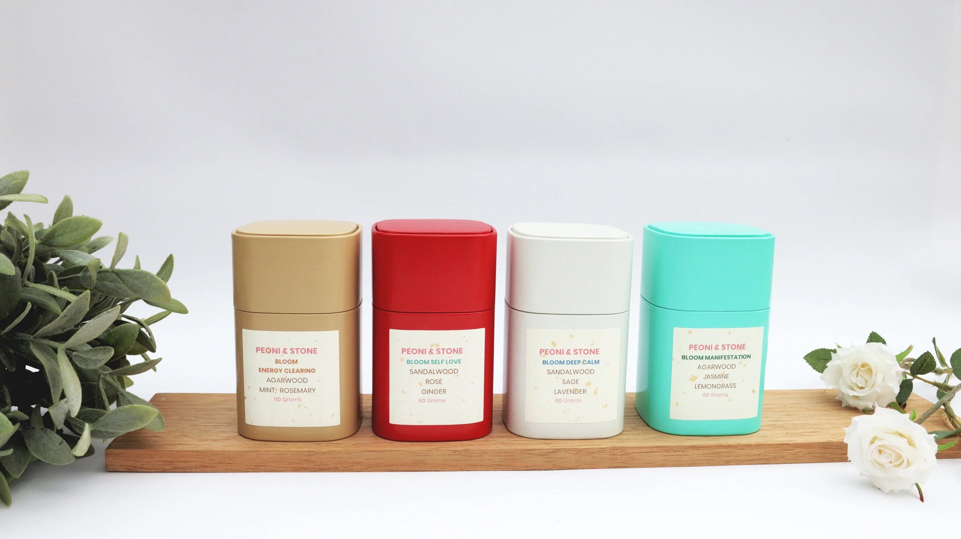 Peoni & Stone Bloom aromatherapy blends in gold, red, white and turquoise jars with natural ingredients