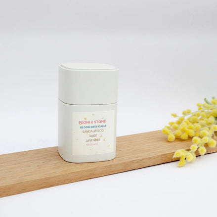 Peoni & Stone Bloom Deep Calm blend with sandalwood sage lavender on wooden board