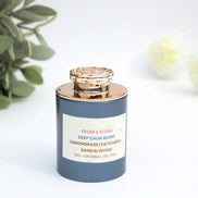 Peoni & Stone Deep Calm essential oil blend with rose gold lid and blue glass bottle