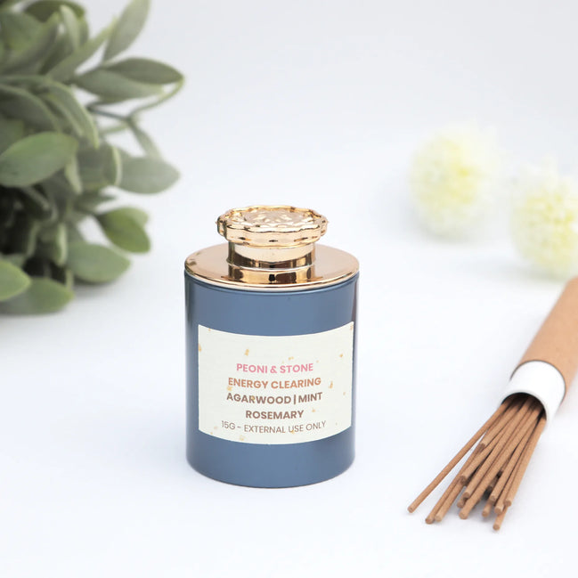 Energy clearing incense blend with agarwood, mint and rosemary in slate blue jar with gold crystal lid