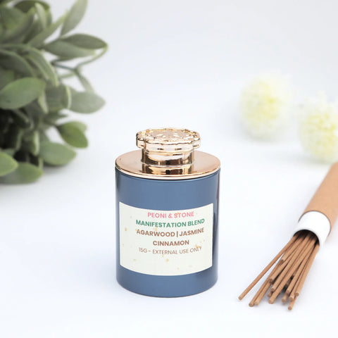 Manifestation blend incense in slate blue jar with gold lid and natural incense sticks