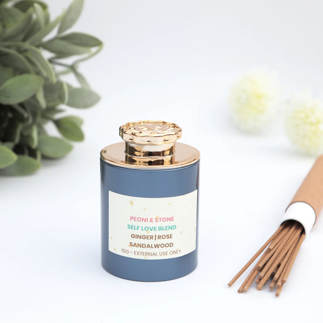 Self Love Blend incense with ginger rose sandalwood in navy jar with gold lid and incense sticks