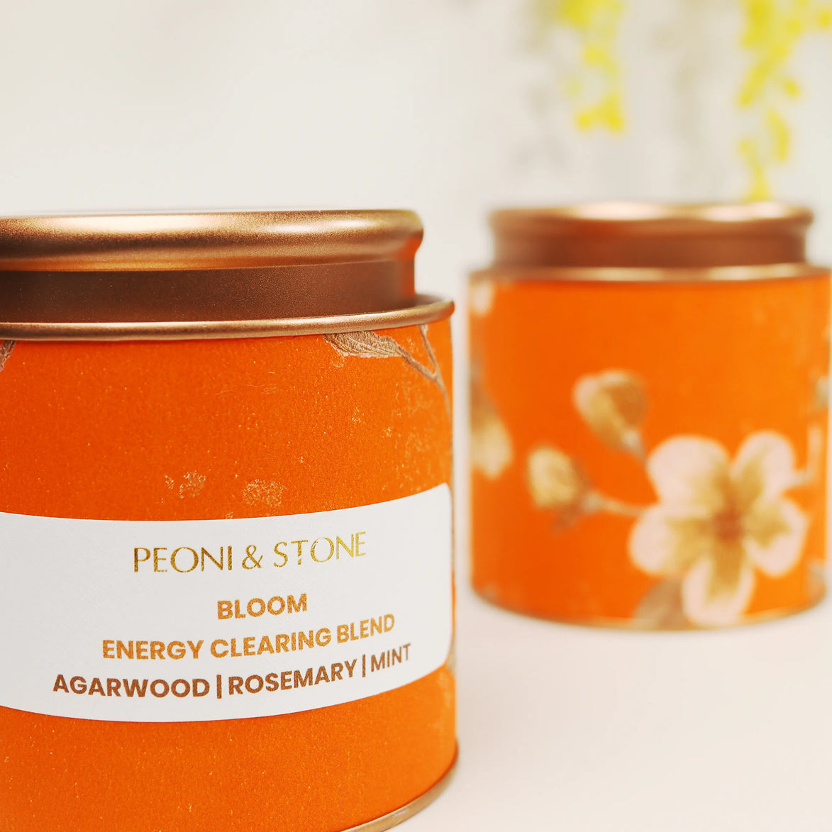 Four colorful Peoni & Stone Bloom aromatherapy jars displayed on wooden tray including yellow Energy Clearing blend