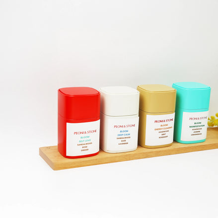 Pile of dried green mint leaves in decorative pink floral bowl with soft lighting and ceramic dishes in background