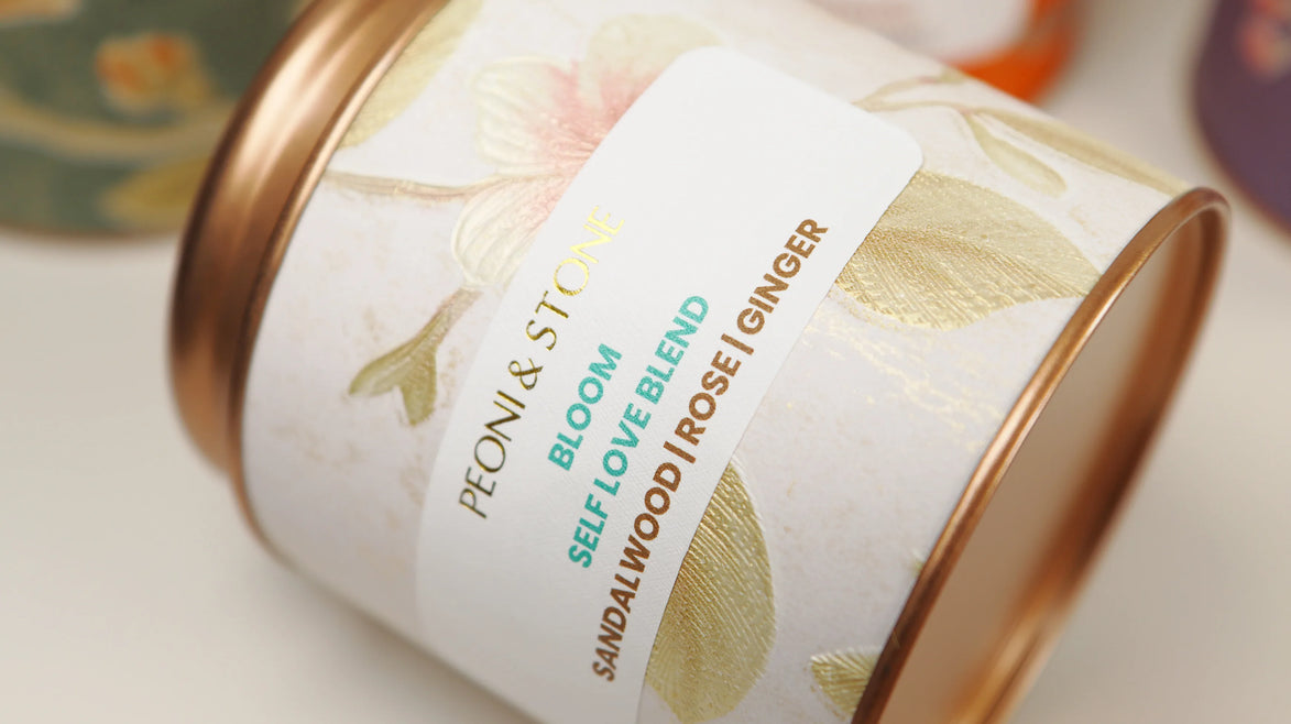 Three white bowls containing dried sandalwood chips, rose petals, and ginger pieces on wooden surface