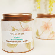 Peoni & Stone Bloom blend tin with copper lid featuring floral design and sandalwood, rose, ginger ingredients