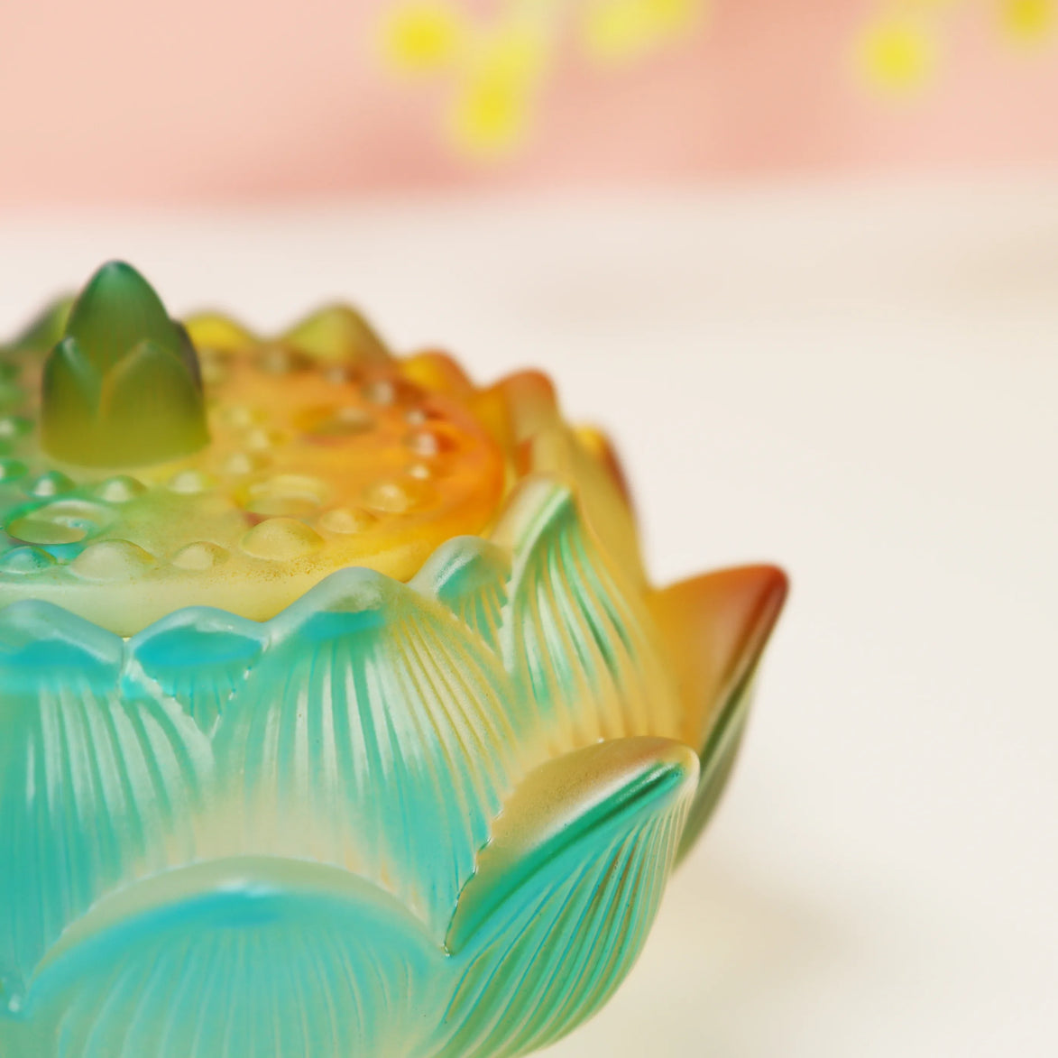 Turquoise and amber ombre glass lotus flower burner with layered petals and detailed leaf engravings