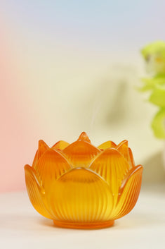 Amber glass lotus-shaped incense burner with layered petal design and translucent golden finish