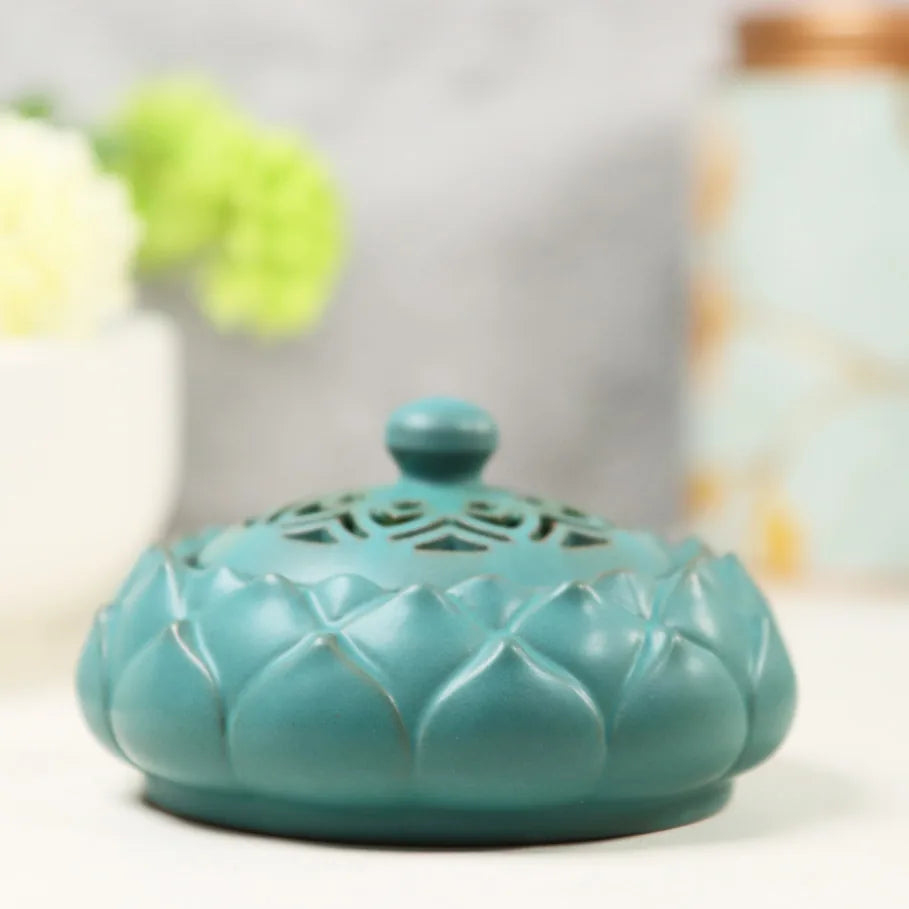 Mist blue ceramic incense burner with lotus petal design and decorative cutout lid on neutral background
