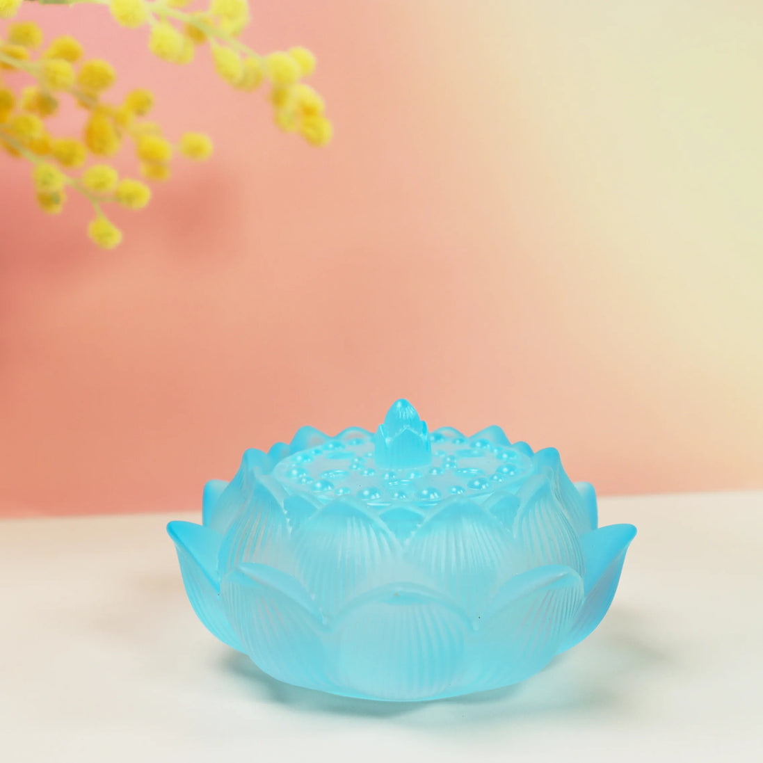 Turquoise frosted glass lotus flower incense burner with detailed petals and sealing lid on neutral background