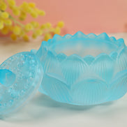 Translucent aqua blue lotus-shaped glass incense burner with scalloped edges and embossed floral pattern