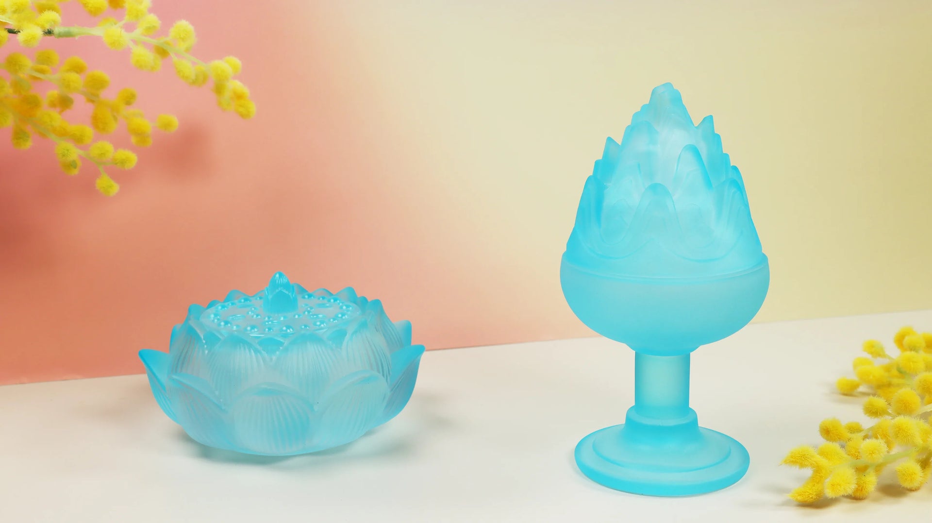 Turquoise translucent glass Boshan incense burner with mountain peak design against neutral background