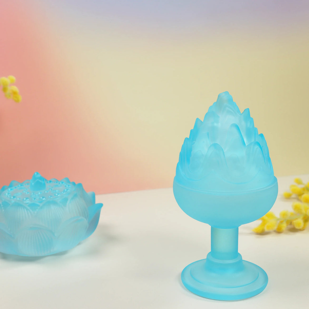 Translucent blue frosted glass boshan incense burner with mountain peak design on pedestal base