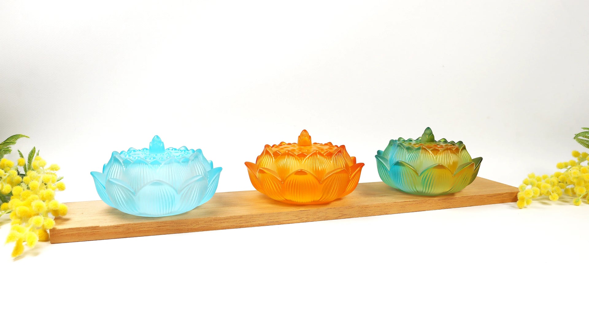 Dawn ombre glass lotus incense holder with brass sealing tools and double happiness seal on white marble surface