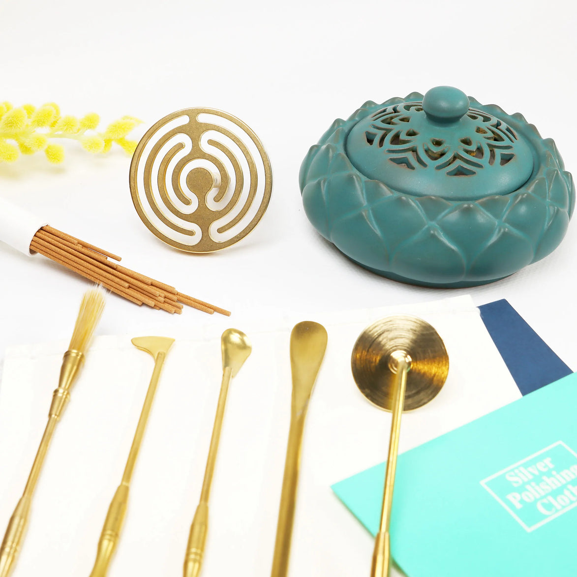 Turquoise ceramic incense burner with lotus lid, brass circular seal mold, wooden sticks, and five brass tools
