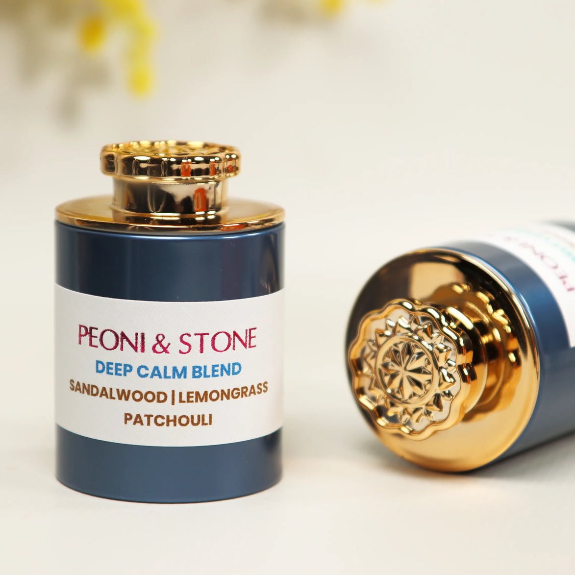 Three ceramic bowls containing natural brown and tan colored incense powder blends on wooden surface