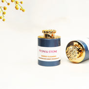 Three ceramic bowls containing natural incense powder in green and beige tones on wooden cutting board