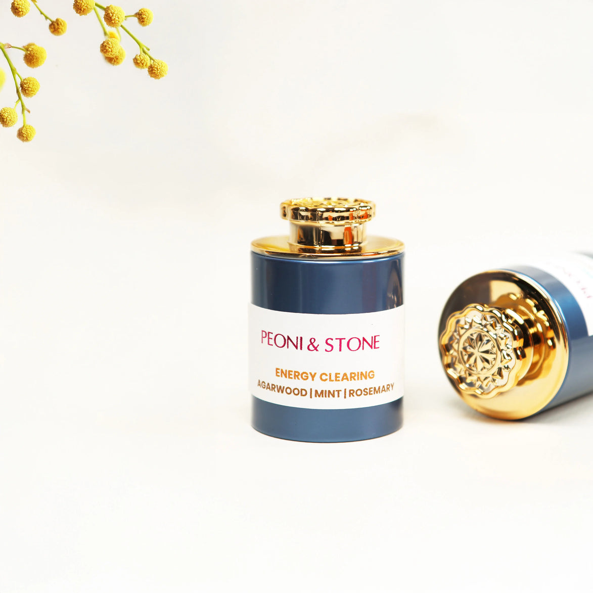 Three ceramic bowls containing natural incense powder in green and beige tones on wooden cutting board