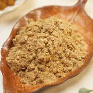 Navy and white glass jar of Peoni & Stone Manifestation Blend incense with gold lid on cream background with yellow flowers