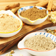 Navy and gold glass incense bottle with ornate cap displaying Peoni & Stone Manifestation Blend label