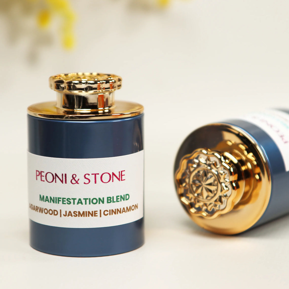 Three ceramic bowls containing different colored natural incense powders on wooden serving board with dried flowers